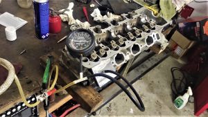 cylinder head rebuild. lapping valves and vacuum testing heads 6